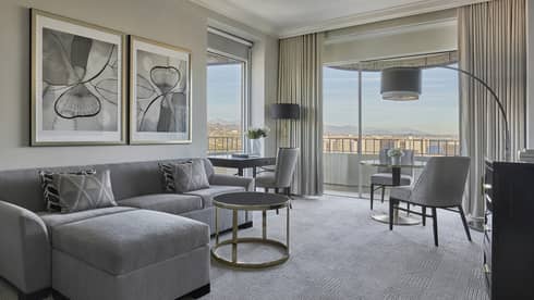 Living room with floor-to-ceiling windows in a Luxury Suite