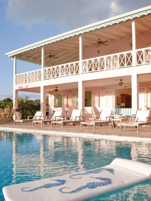 Two-level villa with second floor balcony overlooking outdoor swimming pool