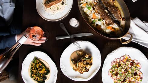 An assortment seafood on white plates.