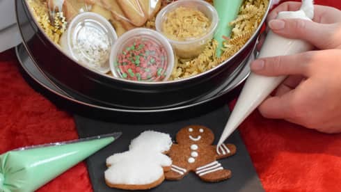 A bowl of icing and sprinkles to decorate gingerbread cookies.