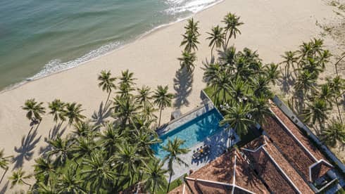 5 Bedroom Beachfront Pool Villa aerial shot with palm trees and ocean views