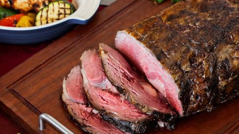 Festive Christmas roasted beef, sliced on a wooden cutting board