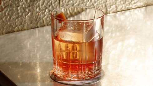A glass of alcohol on a counter.