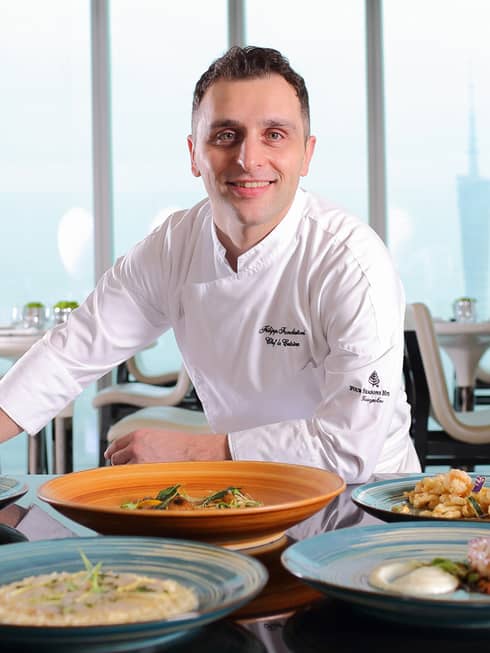 Portrait photo of Caffe Mondo Executive Chef Filippo Fondatori in white chef's uniform