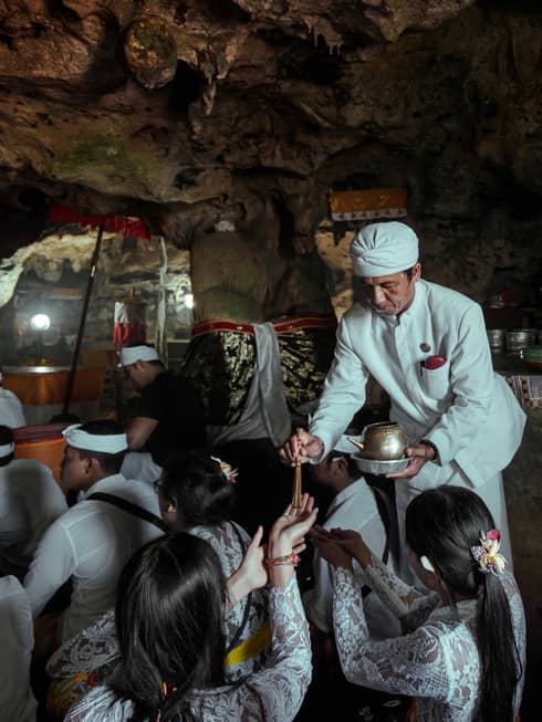A healing ritual is performed within a cave temple