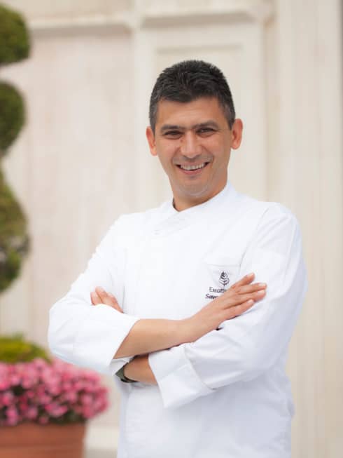 Portrait photo of Executive Chef Savas Aydemir in white uniform