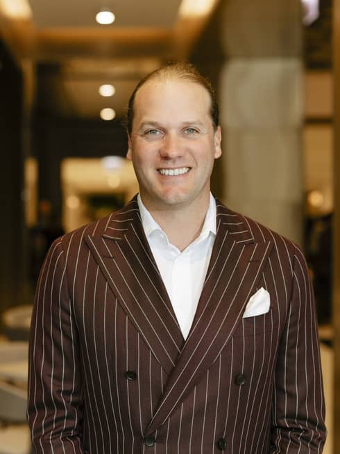 A man in a pin-striped suit.