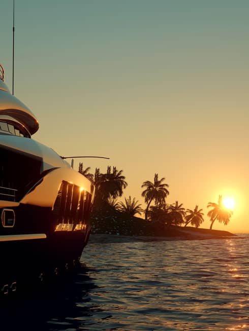 A boat cruises on clear waters at sunset