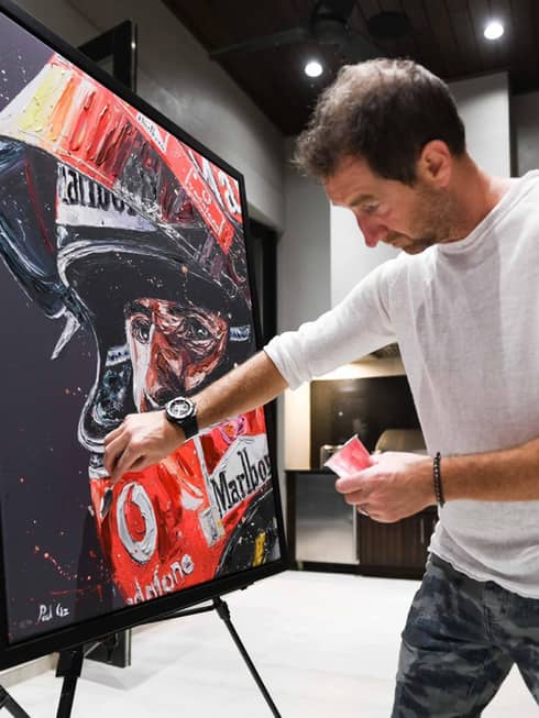 A painter working on a black canvas.