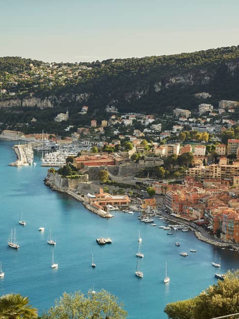 Aerial view of French Riviera waterfront, buildings along coast, yachts, boats in sea