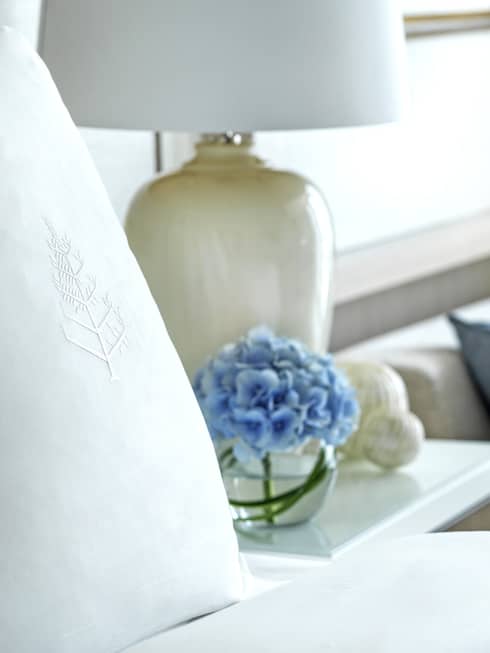 Four Seasons bed, nightstand with lamp, and two-seat sofa