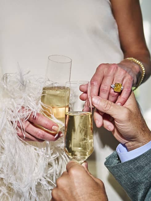 Two people holding glasses of champagne.