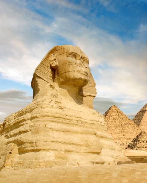 The Sphinx and the great pyramids under interesting evening clouds, Cairo, Egypt
