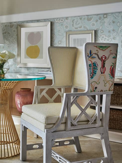 White wood and upholstery chair with colourful pattern of green vervet monkey