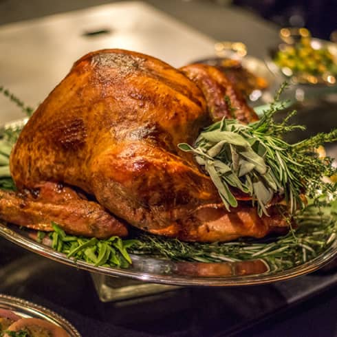 Roast turkey with fresh herbs on silver platter