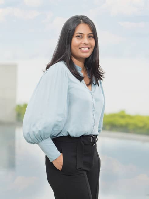 A smiling Resident healer Dr. Tania Bardhan standing at the pool