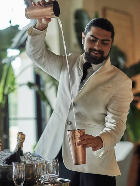 A bartender making a cocktail.