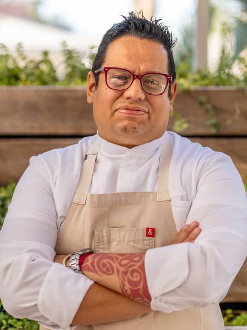 Hugo Bola�os wearing a chef?s coat and apron