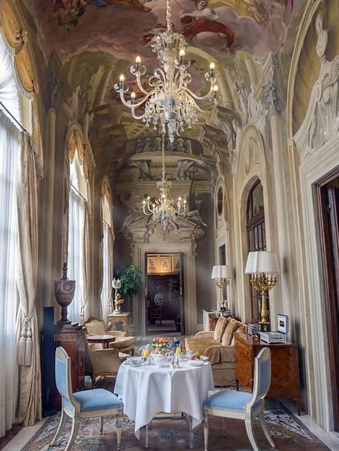Royal Suite in-room dining table, seating room by tall sunny windows, ornate mouldings