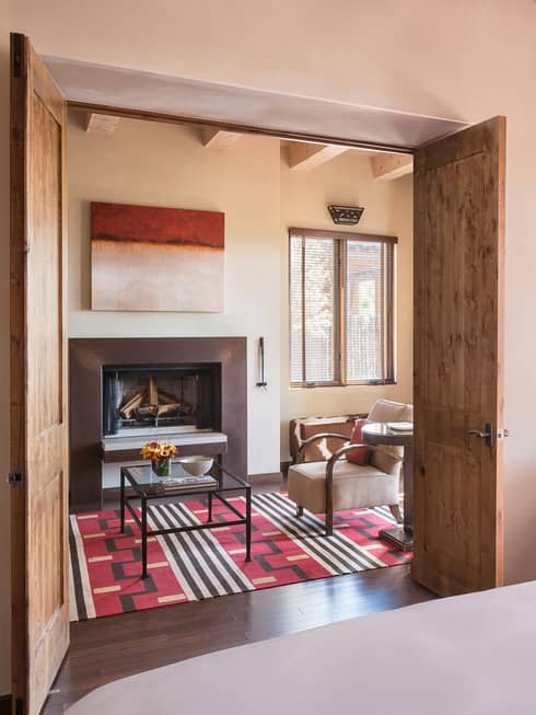 Sunset, Summit Suite bed, chair, open wood doors to seating area, sunny balcony