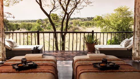 Spa couples massage beds with trays side-by-side in front of patio