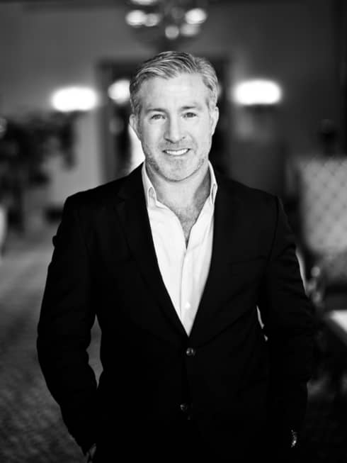 Black-and-white portrait photo of President, Residential Paul White wearing suit jacket