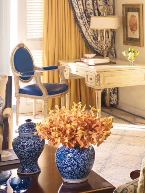 Sea-View One Bedroom Suite table with blue-and-white vases, cherry-wood dresser, flat-screen TV
