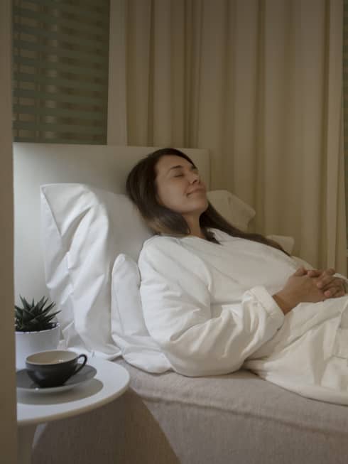 A woman resting on a lounge chair in a spa.