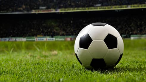 Soccer ball on the grass in a field.