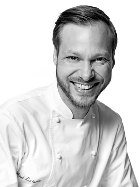 Black and white portrait photo of Chef Michaël Bartocetti in uniform