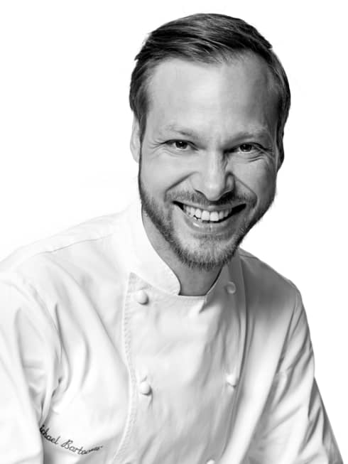 Black and white portrait photo of Chef Michaël Bartocetti in uniform