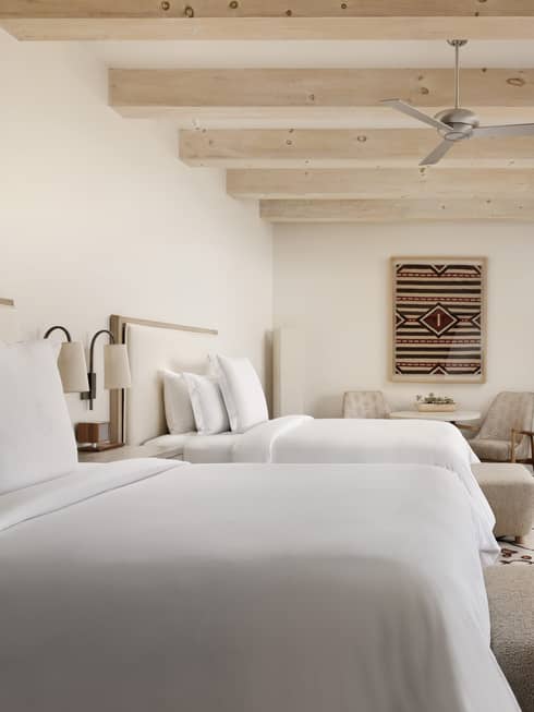 Guest room with two queen beds and walk-out terrace at Four Seasons Resort Santa Fe