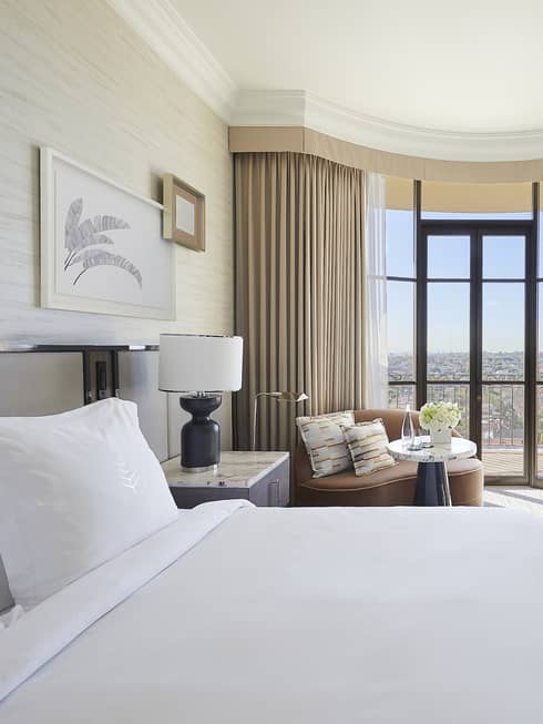 Hotel room with king bed, sitting area and desk