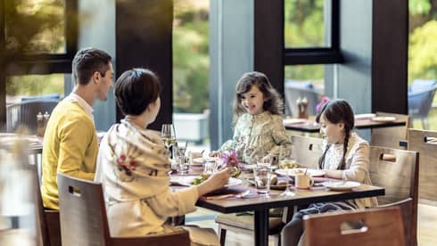 Parents and two young daughters share a meal at Brasserie