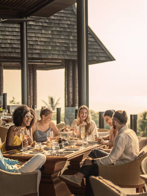 Group of friends enjoys outdoor traditional Thai brunch