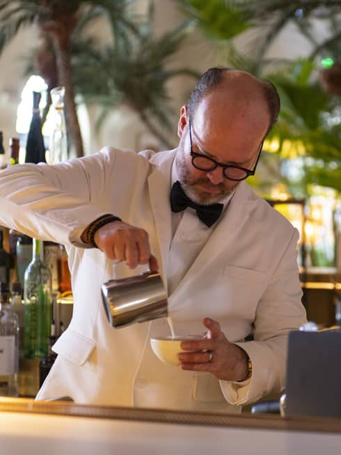 A man making a cappucino.