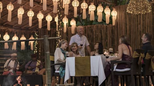 Elephant Camp Dinner, smiling group of diners unders rows of paper lanterns