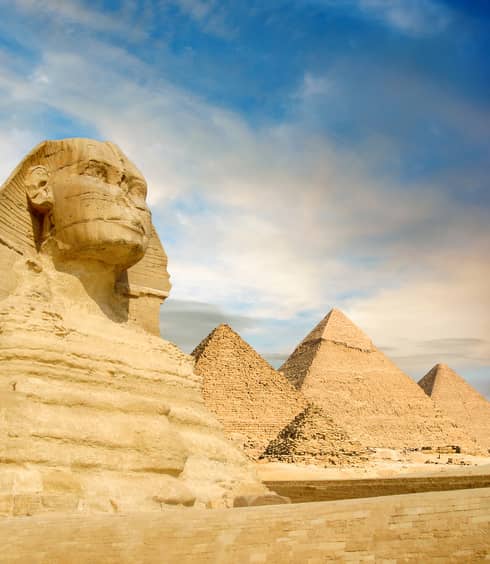 The Sphinx and the great pyramids under interesting evening clouds, Cairo, Egypt