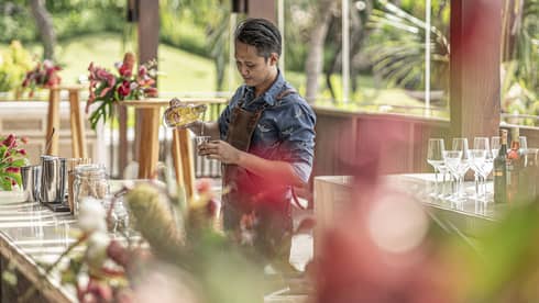 Bartender mixes drink at outdoor bar