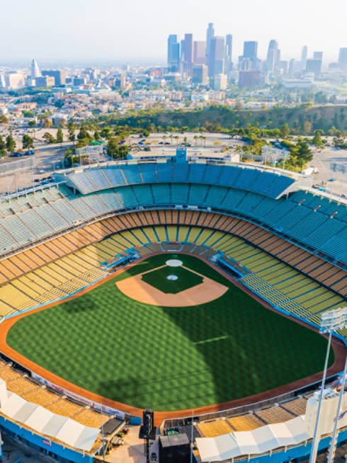 Football stadium with city buildings in the background.