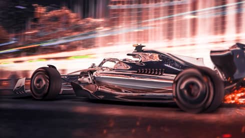 A race car driving quickly near a building.