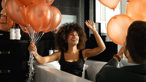 Man and woman playing with balloons