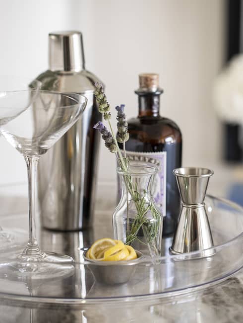 Martini tray with shaker, two martini glasses, a cup of sliced lemons, and a vase with lavender sprigs
