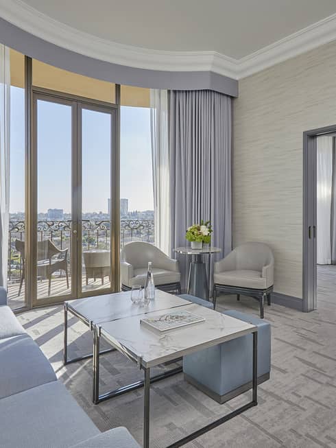 Hotel suite living room with balcony and separate bedroom