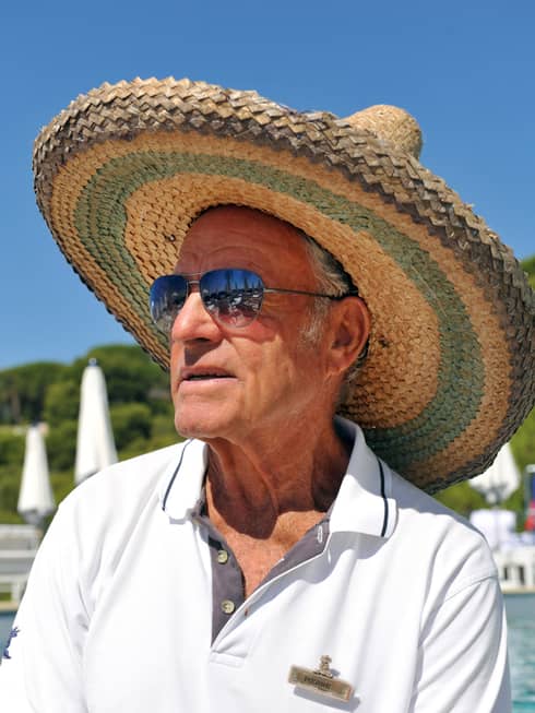 Portrait photo of swimming instructor Pierre Gruneberg wearing sunglasses, straw hat