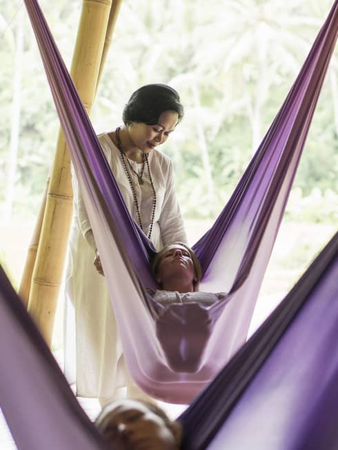 Guests taking a sacred nap in hanging fabric swings