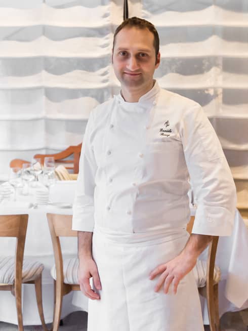 Portrait photo of Executive Pastry Chef Daniele Bonzi standing in white uniform