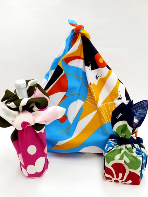 Close-up of bottle, items wrapped in colourful Furoshiki cloth