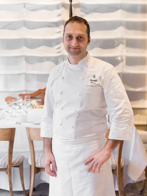Portrait photo of Executive Pastry Chef Daniele Bonzi standing in white uniform