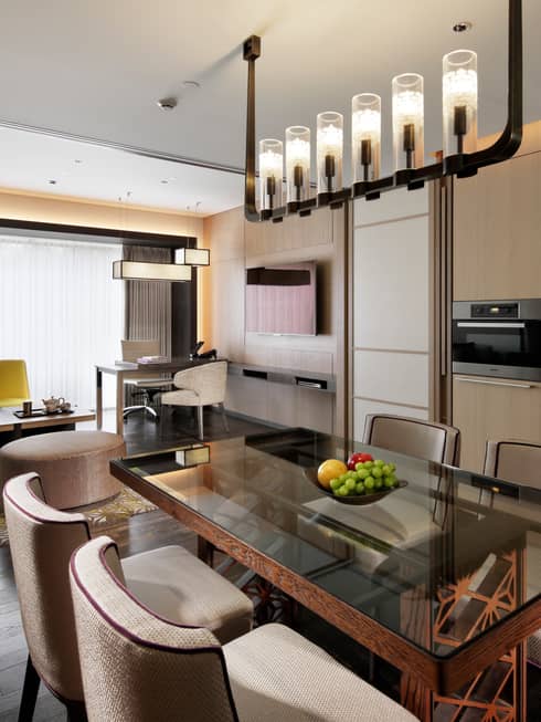 Residence dining table, fruit bowl under candle chandelier, modern kitchen, living room